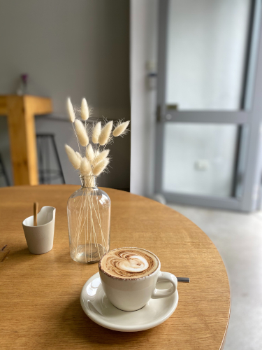 A flat white on a table in a peaceful cafe