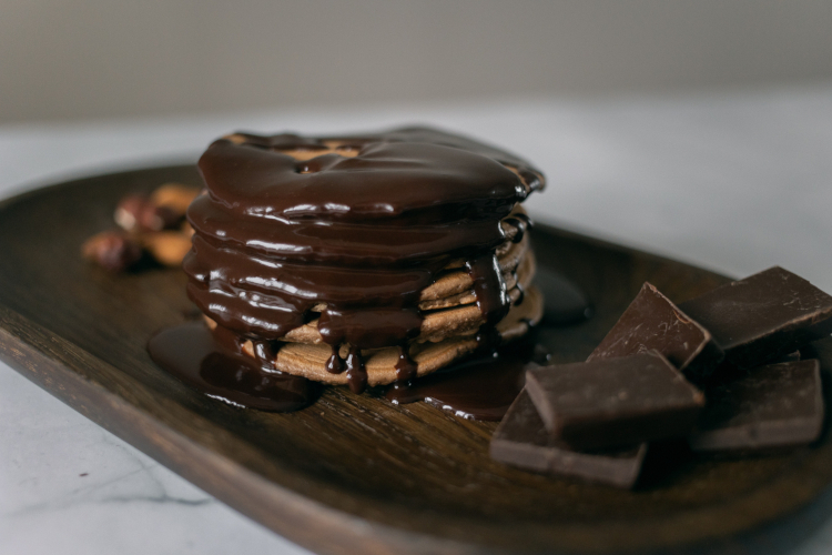Warm cookie stack served with freshly tempered dark or milk chocolate